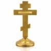 Standkreuz aus Metall goldfarben Rückseite mit Reliefmuster Rückseite des goldfarbenen Standkreuzes aus Metall mit durchgehendem Reliefmuster und glatter Tafel
