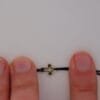 Armband Tiny Cross: kleines Kreuz aus Gold 585 an schwarzer Textilkordel, Ansicht 5