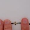 Armband Tiny Cross: kleines Kreuz aus Gold 585 an schwarzer Textilkordel, Ansicht 6
